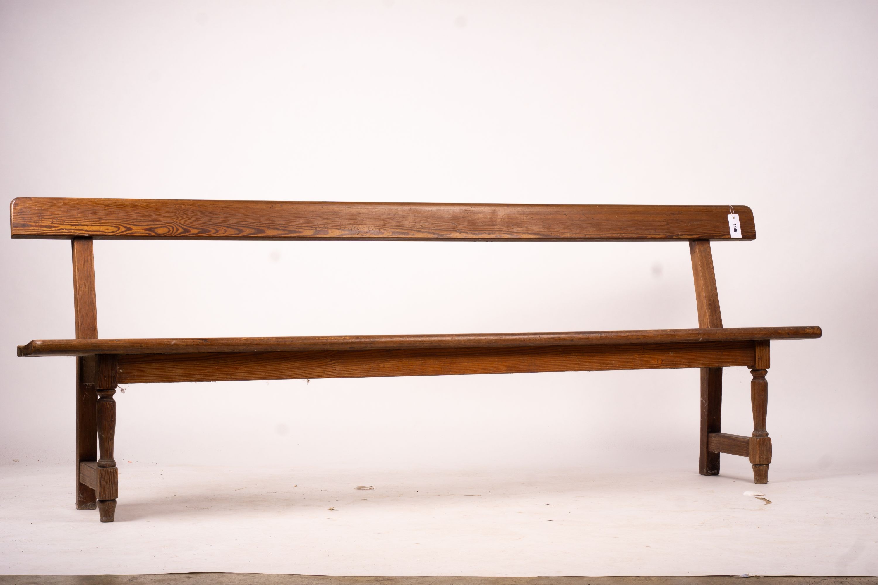 A Victorian pitch pine bench seat, W.214cm H.79cm